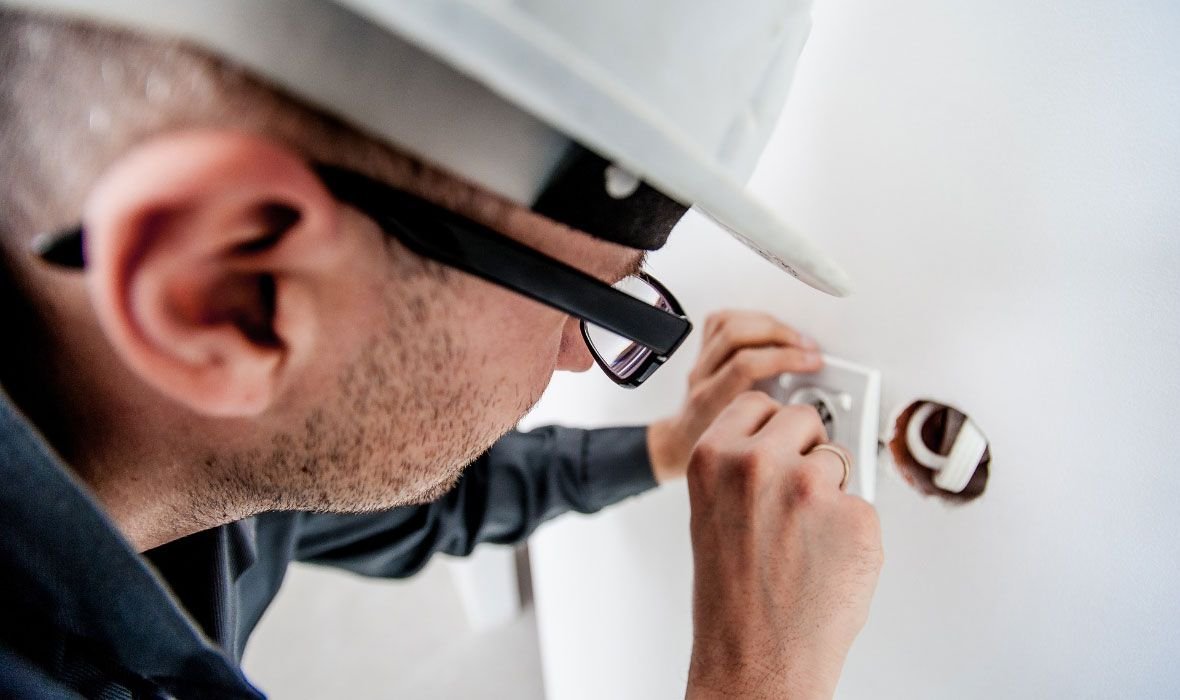 Electrician Repairing Wall Socket
